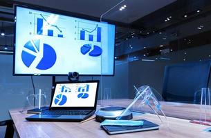 Mock up chart diagram presentation on display laptop and television in meeting room photo