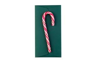 6557 Red candy cane on a green envelope isolated on a transparent background photo