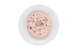 7030 Pink donut on a white plate isolated on a transparent background photo