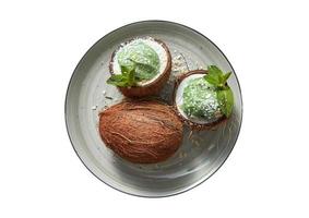 1934 Green plate with coconuts and coconut and ice cream dessert isolated on a transparent background photo