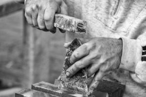 Old retired man hands working slate photo