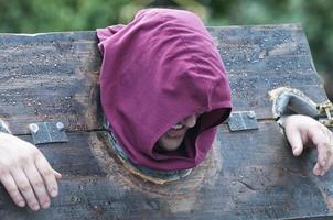 man punished in a pillory photo