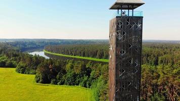 Descending view tourists standing on top Birstonas observation tower - highest such tower in Lithuania. Drone aerial outdoors summer landscape view Nemunas panorama in Birstonas. video