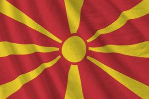 Macedonia flag with big folds waving close up under the studio light indoors. The official symbols and colors in banner photo
