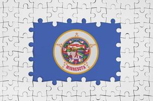 Minnesota US state flag in frame of white puzzle pieces with missing central part photo