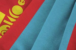 Mongolia flag with big folds waving close up under the studio light indoors. The official symbols and colors in banner photo