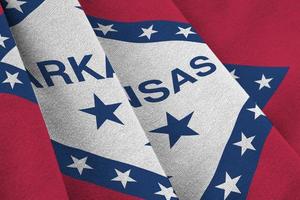 Arkansas US state flag with big folds waving close up under the studio light indoors. The official symbols and colors in banner photo