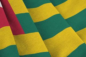 Togo flag with big folds waving close up under the studio light indoors. The official symbols and colors in banner photo