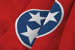 Tennessee US state flag with big folds waving close up under the studio light indoors. The official symbols and colors in banner photo