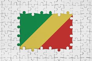 Congo flag in frame of white puzzle pieces with missing central part photo