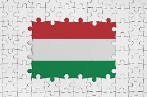 Hungary flag in frame of white puzzle pieces with missing central part photo