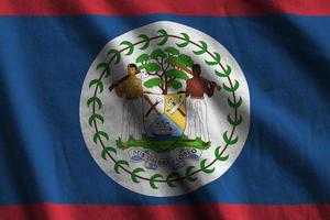 Belize flag with big folds waving close up under the studio light indoors. The official symbols and colors in banner photo