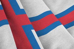 Faroe islands flag with big folds waving close up under the studio light indoors. The official symbols and colors in banner photo