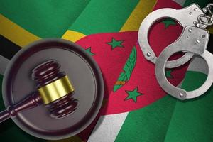 Dominica flag with judge mallet and handcuffs in dark room. Concept of criminal and punishment, background for judgement topics photo