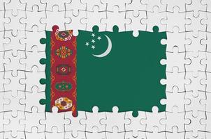 Turkmenistan flag in frame of white puzzle pieces with missing central part photo