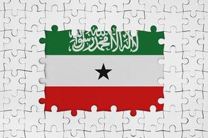 Somaliland flag in frame of white puzzle pieces with missing central part photo