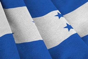 Honduras flag with big folds waving close up under the studio light indoors. The official symbols and colors in banner photo