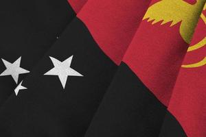 Papua New Guinea flag with big folds waving close up under the studio light indoors. The official symbols and colors in banner photo