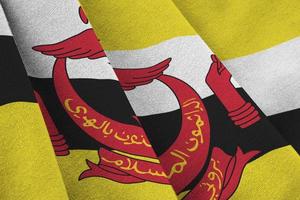 Brunei Darussalam flag with big folds waving close up under the studio light indoors. The official symbols and colors in banner photo