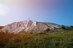 Ancient multimillion chalk mountains on the steppe surface of earth photo