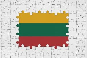 Lithuania flag in frame of white puzzle pieces with missing central part photo