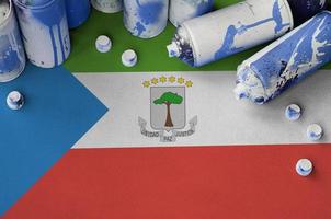 Equatorial Guinea flag and few used aerosol spray cans for graffiti painting. Street art culture concept photo