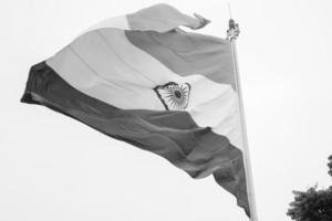 India flag flying high at Connaught Place with pride in blue sky, India flag fluttering, Indian Flag on Independence Day and Republic Day of India, tilt up shot, Waving Indian flag, Har Ghar Tiranga photo