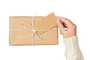 6464 Beige gift box held by a woman's hands isolated on a transparent background photo