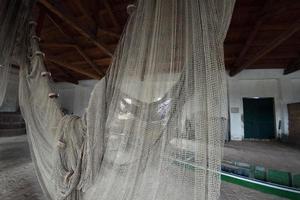 handmade old fishing net inside fisherman house photo