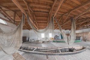 handmade old fishing net inside fisherman house photo