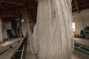 handmade old fishing net inside fisherman house photo