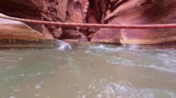 Tourist in Wadi Mujib gorge in Jordan which enters the Dead Sea at 410 meters below sea level. The Mujib Reserve of Wadi Mujib is the lowest nature reserve in the world video