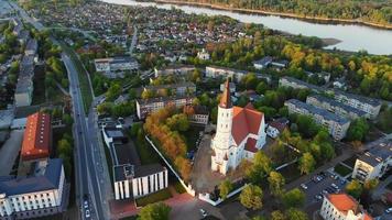 Beautiful panoramic aerial 4K video flying drone above sun city Siauliai panorama in Lithuania. Sunset cinematic Europe destinations