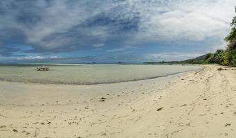 seychelles sand beach in praslin with catamaran photo