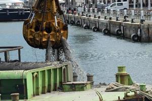 Harbor port dredge working on sea photo