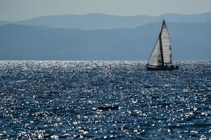 small sailboat at sunset photo