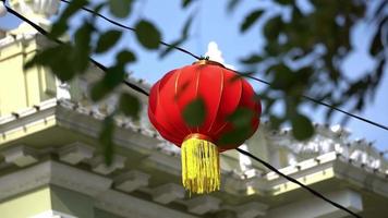 Select focus red lantern hanging at background video