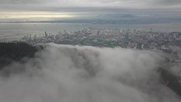 Aerial view over low cloud at tropical rainforest. video