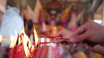 Devotees hand hold the candle burn video