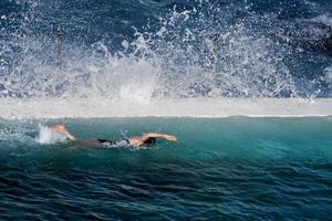 An isolatesd swimmer in a close vy the sea pool photo