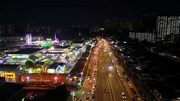 Aerial nightscape car traffic and funfair Pesta video