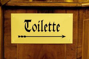 Toilette wc arrow sign on copper old style german photo