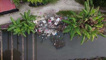 Aerial view illegal garbage dump near the river video