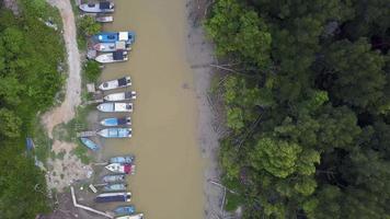 Aerial top down view fishing boats park near river