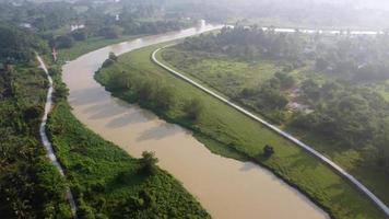 Aerial move over river Sungai Perai in misty day video