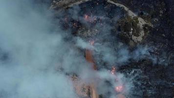 Aerial top down view fire burning at landfill site video