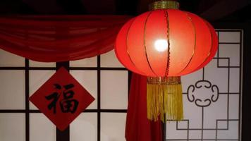 Select focus lighted red chinese lantern and hanging fu on front door video