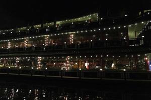 amsterdam canal at night view floating restaurant photo