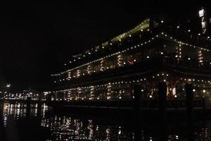 amsterdam canal at night view floating restaurant photo