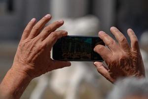 Selfie with smartphone at Trevi Fountain crowded of tourists Rome Italy photo